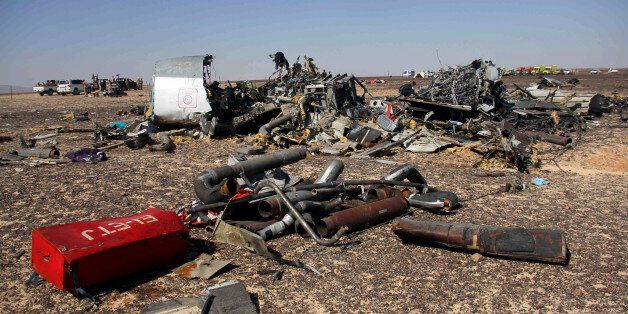 Egyptian security forces stand guard by debris of a Russian airplane at the site a day after the passenger jet bound for St. Petersburg, Russia crashed in Hassana, Egypt, on Sunday, Nov. 1, 2015. The Metrojet plane, bound for St. Petersburg in Russia, crashed 23 minutes after it took off from Egypt's Red Sea resort of Sharm el-Sheikh on Saturday morning. The 224 people on board, all Russian except for four Ukrainians and one Belarusian, died. (AP Photo)