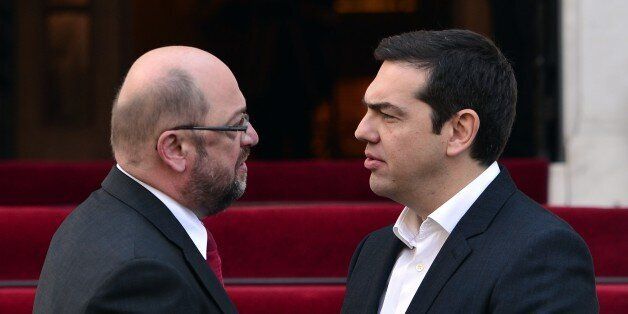 Greek prime minister Alexis Tsipras (R) greets European Parliament President Martin Schulz prior to their talks in Athens on November 4, 2015. The first refugees were leaving Greece on November 4 under a relocation plan to ease pressure on countries bearing the brunt of Europe's migrant crisis, with 30 Syrians and Iraqis heading to start new lives in Luxembourg. AFP PHOTO/LOUISA GOULIAMAKI (Photo credit should read LOUISA GOULIAMAKI/AFP/Getty Images)