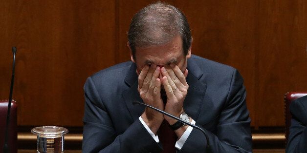 Portuguese Prime Minister Pedro Passos Coelho rubs his eyes during the debate of the government's four-year policy program at the Parliament in Lisbon, Tuesday, Nov. 10 2015. Together the left-of-center parties have 122 seats in the 230-seat Parliament, outnumbering the government, and have vowed to reject the program in a vote. Such a defeat would force the government, which took office on Oct. 30, to resign, possibly opening the door for the unprecedented leftist alliance to take over. (AP Pho