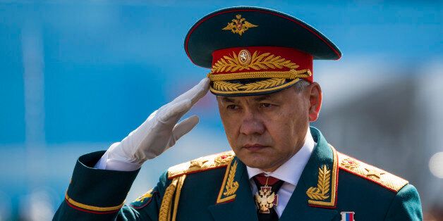 Russian Defence Minister Sergei Shoigu salutes to his soldiers as he is driven along the Red Square, during the Victory Parade marking the 70th anniversary of the defeat of the Nazi Germany in World War II, in Moscow, Russia, Saturday, May 9, 2015. (AP Photo/Alexander Zemlianichenko, pool)
