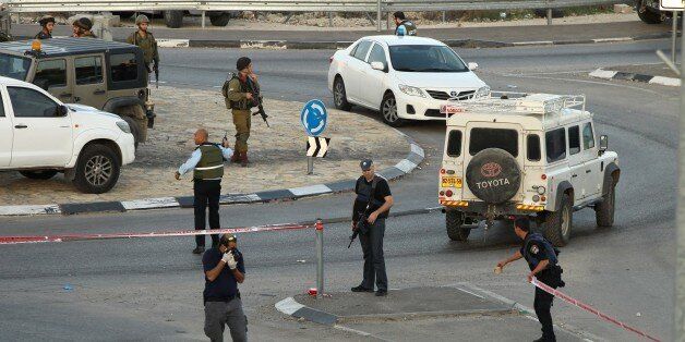 Israeli security forces cordon off the site of a reported car-ramming attack on Israeli border guards at the Beit Einun junction, north of the West Bank city of Hebron, on November 1, 2015. Earlier in the day, a Palestinian tried to stab an Israeli soldier and was shot dead in the same area, the Israeli army said. AFP PHOTO / HAZEM BADER (Photo credit should read HAZEM BADER/AFP/Getty Images)