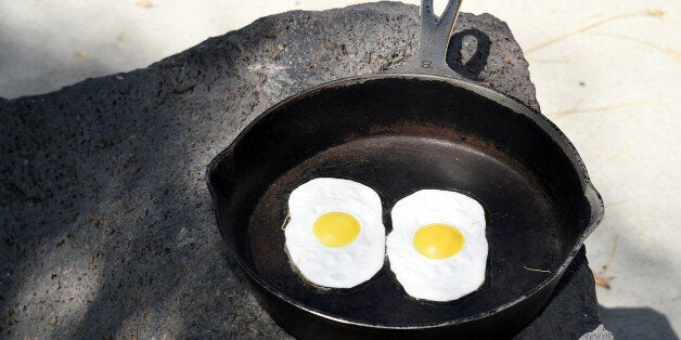 BAKER, CA - JULY 23: Fake eggs in a frying pan are displayed near a 134-foot-high electronic sign that gives the temperature on July 23, 2014 in Baker, California. The landmark roadside attraction, visible to drivers along Interstate 15 and billed as the 'World's Largest Thermometer,' was relit earlier this month for the first time since 2012, after a renovation that included replacing its 5,000 light bulbs with LEDs. (Photo by Ethan Miller/Getty Images)