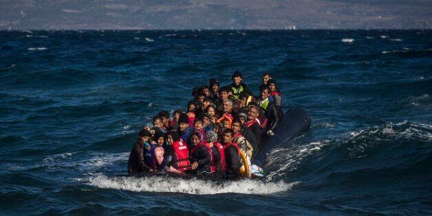 Afghan migrants on an overcrowded inflatable boat approach the Greek island of Lesbos in bad weather after crossing the Aegean see from Turkey, Wednesday, Oct. 28, 2015. Greeceâs government says it is preparing a rent-assistance program to cope with a growing number of refugees, who face the oncoming winter and mounting resistance in Europe. (AP Photo/Santi Palacios)