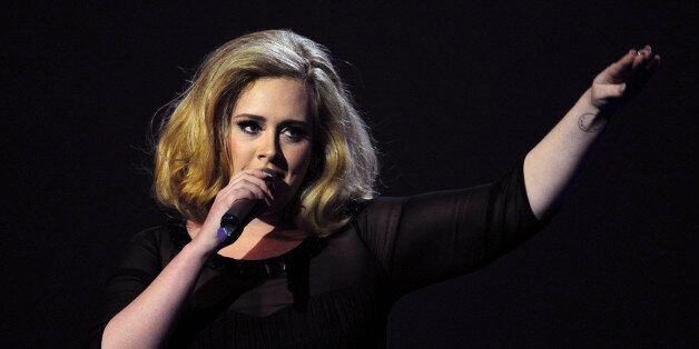 British singer-songwriter Adele accepts the British Female Solo Artist award at the BRIT Awards 2012 in London on February 21, 2012. AFP PHOTO / LEON NEAL (Photo credit should read LEON NEAL/AFP/Getty Images)