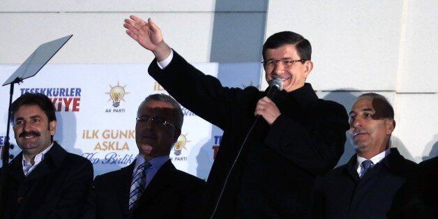 Turkish Prime Minister Ahmet Davutoglu addresses supporters from the balcony of the Justice and Development Party (AKP) headquarters in Ankara on November 1, 2015. Turkey's long-dominant Justice and Development Party (AKP) scored a stunning electoral comeback, regaining its parliamentary majority in a poll seen as pivotal for the future of the troubled country. AFP PHOTO / ADEM ALTAN (Photo credit should read ADEM ALTAN/AFP/Getty Images)