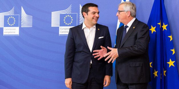 European Commission President Jean-Claude Juncker, right, welcomes Greece's Prime Minister Alexis Tsipras upon his arrival at the EU Commission headquarters in Brussels on Wednesday, Sept. 23, 2015. The European Union hopes to provide more funds for refugees and agree short and long term measures to confront the migration crisis. (AP Photo/Geert Vanden Wijngaert)