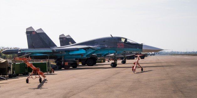 Two Russian Su-30 fighter jet parked at Hemeimeem airbase, Syria, Thursday, Oct. 22, 2015. Nearly a quarter of a century after the Soviet collapse, the air campaign in Syria has proven that the resurgent Russian military machine could again operate far away from the nation's borders. (AP Photo/Vladimir Isachenkov)