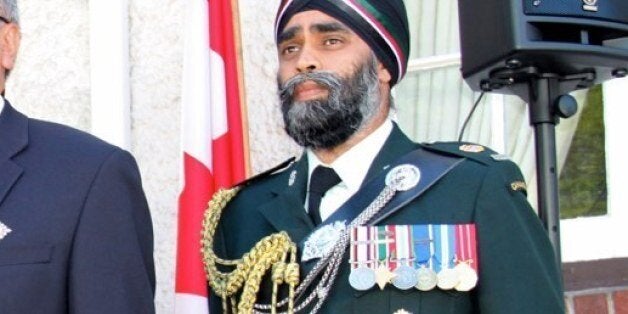 Lt. Gov. Steven Point, fore, and Lt. Col. Harjit Sajjan (r.) share the stage with Consul General Phil Chicola during the ceremonial portion of the Independence Day event.