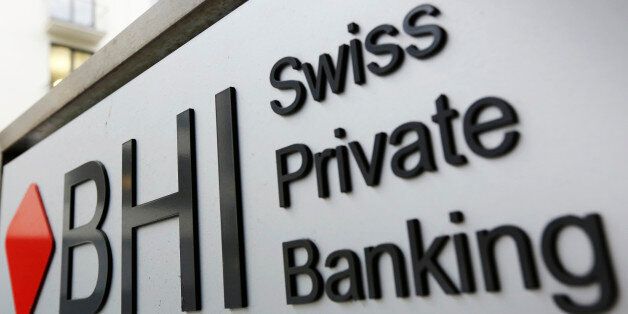 A sign sits outside Bank Hapoalim B.M. in Zurich, Switzerland, on Tuesday, Oct. 13, 2015. Once bastions of secrecy, 41 Swiss banks signed amnesty agreements this year with the U.S. Justice Department that required disclosing the tricks they used to help customers hide assets, naming bankers and middlemen who enabled them and detailing the flow of untaxed money. Photographer: Luke MacGregor/Bloomberg via Getty Images
