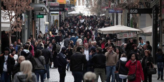 Shoppers are seen on Athens' main commercial Ermou Street, on Monday, Feb. 6, 2012. Parties backing Greece's...