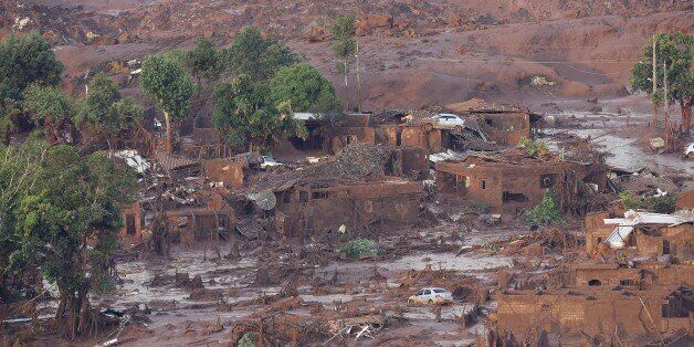 A general view where a dam burst in the village of Bento Rodrigues, in Mariana, the southeastern Brazilian state of Minas Gerais on November 6, 2015. A dam burst at a mining waste site, unleashing a deluge of thick, red toxic mud that smothered a village and killed at least 17 people, an official said. The mining company Samarco, which operates the site, is jointly owned by two mining giants, Vale of Brazil and BHP Billiton of Australia. AFP PHOTO / Douglas MAGNO (Photo credit should r
