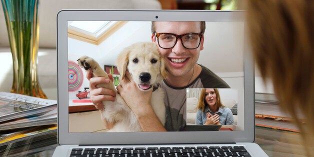 Guy showing off his new puppy over Skype.