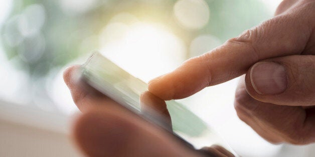 Close up of mans hand using smartphone