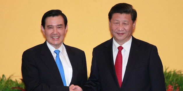 Taiwan's President Ma Ying-jeou, left, and China's President Xi Jinping shake hands at the Shangri-la Hotel on Saturday, Nov. 7, 2015, in Singapore. The two leaders shook hands at the start of a historic meeting, marking the first top level contact between the formerly bitter Cold War foes since they split amid civil war 66 years ago. (AP Photo/Chiang Ying-ying)