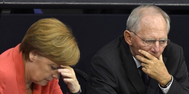 German Chancellor Angela Merkel (L) confer with finance minister Wolfgang Schaeuble during a debate in the Bundestag, the German lower house of parliament in Berlin on July 17, 2015. German lawmakers will vote during todays sitting in the Bundestag on entering into negotiations on the new aid package for Greece. AFP PHOTO / TOBIAS SCHWARZ (Photo credit should read TOBIAS SCHWARZ/AFP/Getty Images)