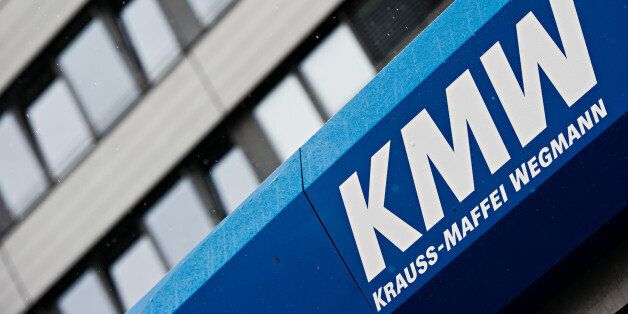 The logo of German company Krauss-Maffei-Wegmann GmbH & Co. KG is photographed at a factory in Munich, Germany, Wednesday July 2, 2014. German defense company Kraus-Maffei Wegmann and France's Nexter Systems have announced plans for an alliance that they say will make it possible to keep jobs and skills in Europe. The two companies, whose products include tanks, armored personnel carriers and artillery systems, said late Tuesday that they plan to ally under a joint holding company. The two firms' current owners each will receive 50 percent of the shares in the holding company. (AP Photo/dpa, Nicolas Armer)