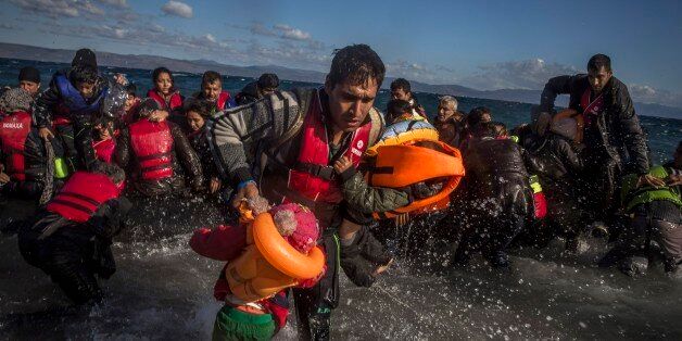 Afghan migrants disembark safely from their frail boat in bad weather on the Greek island of Lesbos after crossing the Aegean see from Turkey, Wednesday, Oct. 28, 2015. Greeceâs government says it is preparing a rent-assistance program to cope with a growing number of refugees, who face the oncoming winter and mounting resistance in Europe. (AP Photo/Santi Palacios)