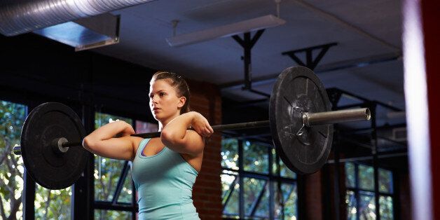 Woman In Gym Lifting Weights