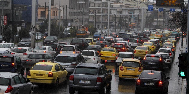 Cars and taxis are caught in a traffic jam during a 24-hour strike held by metro, tram and urban railway unions in Athens, Friday, Jan. 18, 2013. Workers at Athens metro, tram and urban railway system have walked off the job, striking to protest salary cuts that are part of harsh austerity measures the country is taking to get its hands on bailout cash it needs to avoid bankruptcy. (AP Photo/Thanassis Stavrakis)