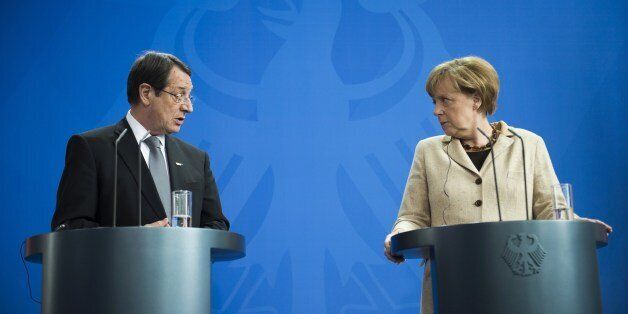 German Chancellor Angela Merkel (R) and President of Cyprus Nicos Anastasiades speak at a joint press conference following a meeting at the Chancellery in Berlin on May 6, 2014. AFP PHOTO / ODD ANDERSEN (Photo credit should read ODD ANDERSEN/AFP/Getty Images)