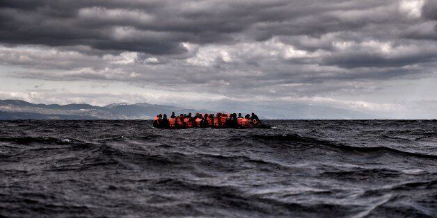 Refugees and migrants sail towards the Greek island of Lesbos on October 25, 2015 as they cross the Aegean sea from Turkey. At least three migrants -- two children and a woman -- drowned when their boat sank off the Greek island of Lesbos, the coastguard said, the latest fatalities in Europe's refugee crisis. Around a dozen others, mostly Afghans, are still missing after the rickety vessel, carrying 60 people, went down at dawn as it made the perilous crossing from Turkey, according to the Gree