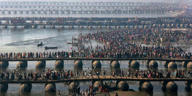 FILE - In this Feb. 10, 2013 file photo, Hindu devotees walk across pontoon bridges to take a holy dip at Sangam, the confluence of the Ganges, Yamuna and mythical Saraswati River, during the Maha Kumbh festival, in Allahabad, India. Philippine officials estimate that as many as 6 million people will attend the Mass that Pope Francis celebrates Sunday, Jan. 18, 2015 in Manilaâs Rizal Park. That would be a record for any pope, but not for any event. A look at some of the biggest gatherings of humanity: (AP Photo/Manish Swarup, File)
