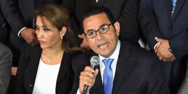 President-elect Jimmy Morales, of the National Front Convergence, delivers a speech next to his wife Hilda Marroquin, after winning the run-off election, in Guatemala City on October 25, 2015. Comedian Jimmy Morales jumped to a massive lead in Guatemala's presidential race Sunday, declaring victory after a campaign upended by a corruption scandal that felled the outgoing president. Morales, a comic actor and TV personality with no political experience, had 69 percent of the vote to 31 percent fo
