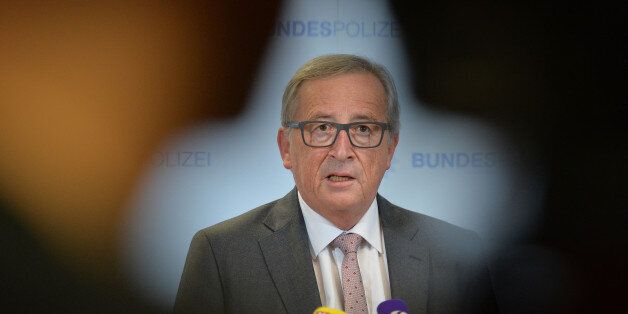 President of the European Commission Jean-Claude Juncker speaks to media during a visit of a migrants registration center in Passau, southern Germany, Thursday, Oct. 8, 2015. (AP Photo/Kerstin Joensson)