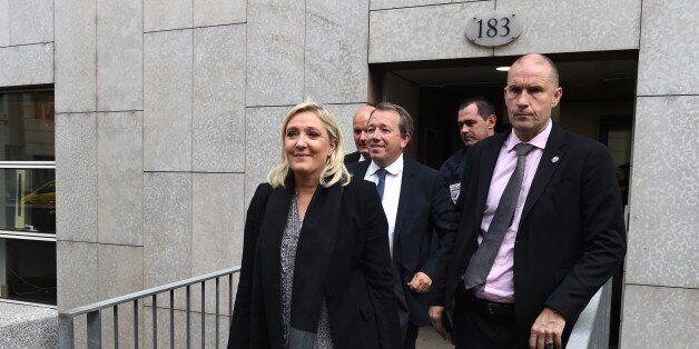 France far-right leader Marine Le Pen leaves the court on October 20, 2015 in Lyon, after facing charges of inciting racial hatred after comparing Muslim street prayers to the Nazi occupation. Le Pen was campaigning to take over leadership of the Front National (FN) from her father in December 2010 when she made the comparison, complaining that there were '10 to 15' places in France where Muslims worshipped in the streets outside mosques when they were full. AFP PHOTO / PHILIPPE DESMAZES