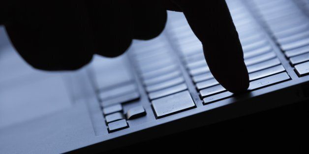 BERLIN, GERMANY - AUGUST 20: Symbolic feature with topic online crime, data theft and piracy, here a finger on the keyboard of a computer, on Augut 20, 2015 in Berlin, Germany. (Photo by Thomas Trutschel/Photothek via Getty Images)