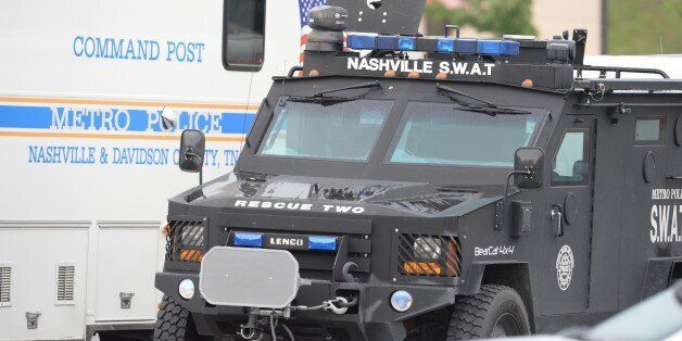 ANTIOCH, TN - AUGUST 05: SWAT and Nashville Metro Police trucks park outside Hickory Hollow Cinemas on August 5, 2015 in Antioch, Tennessee. According to reports, an unidentified 29-year-old man armed with a gun and hatchet sprayed three people with a chemical believed to be pepper spray and injured another with a minor wound from the hatchet. The man was later killed by police after exchanging fire outside the theater. (Photo by Jason Davis/Getty Images)