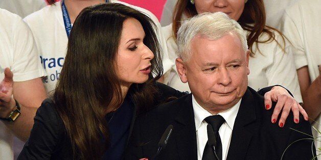 Jaroslaw Kaczynski (R), leader of the conservative opposition Law and Justice (PiS) is congratulated by Marta Kaczynska, daughter of late president Lech Kaczynski, after exit poll results were announced on October 25, 2015. Poland's conservative Law and Justice (PiS) party won an absolute majority in the general election, public broadcaster TVP projected, a victory that would end eight years of centrist rule. An exit poll showed the PiS picked up 242 out of 460 seats in the lower house of parliament, ousting the governing Civic Platform (PO) liberals who had 133 seats.announcing the first unofficial results of the general election in Poland on October 25, 2015. AFP PHOTO/JANEK SKARZYNSKI (Photo credit should read JANEK SKARZYNSKI/AFP/Getty Images)