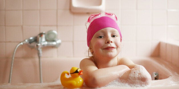 A 5 years old girl taking her bath