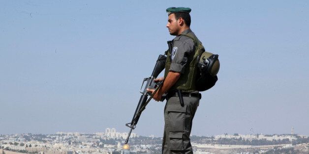 An Israeli border policeman stands on a hill overlooking Jerusalem's Old City, Saturday, Oct. 17, 2015. Palestinian assailants carried out a series of five stabbing attacks in Jerusalem and the West Bank on Saturday, as a month-long outburst of violence showed no signs of abating. The unrest came despite new security measures that have placed troops and checkpoints around Palestinian neighborhoods in east Jerusalem. (AP Photo/Mahmoud Illean)