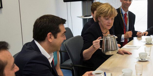 Greek Prime Minister Alexis Tsipras, left, and German Chancellor Angela Merkel are pictured during a meeting with European Commission President Jean-Claude Juncker and French President Francois Hollande prior to a euro zone leaders summit in Brussels, Belgium, Tuesday, July 7, 2015. Greece faces a last chance to stay in the euro zone on Tuesday when Prime Minister Alexis Tsipras puts proposals to an emergency euro zone summit after Greek voters resoundingly rejected the austerity terms of a defunct bailout. (Philippe Wojazer/Pool Photo via AP)