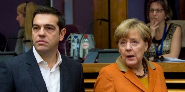 German Chancellor Angela Merkel, right, and Greek Prime Minister Alexis Tsipras arrive for a round table meeting during an EU summit at EU headquarters in Brussels on Sunday, Oct. 25, 2015. EU leaders meet on Sunday to discuss refugee flows along the Western Balkans route. (AP Photo/Virginia Mayo)