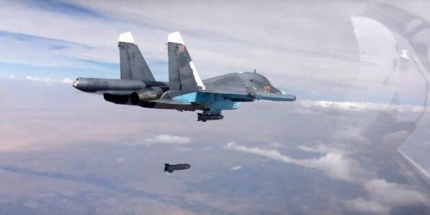 FILE - In this file photo made from the footage taken from Russian Defense Ministry official website on Friday, Oct. 9, 2015, a bomb is released from Russian Su-34 strike fighter in Syria. Hundreds of Iranian troops are being deployed in northern and central Syria, dramatically escalating Tehranâs involvement in the civil war as they join allied Hezbollah fighters in an ambitious offensive to wrest key areas from rebels amid Russian airstrikes. (Russian Defense Ministry Press Service via AP, File)