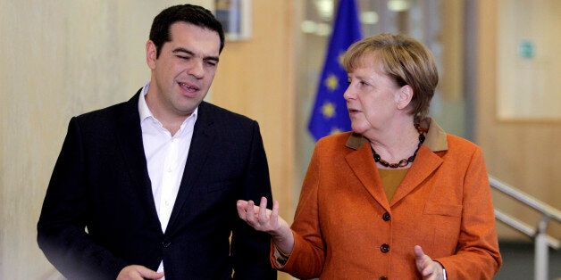 German Chancellor Angela Merkel, right, speaks with Greek Prime Minister Alexis Tsipras prior to a round table meeting during an EU summit at EU headquarters in Brussels on Sunday, Oct. 25, 2015. EU leaders meet on Sunday to discuss refugee flows along the Western Balkans route. (AP Photo/Francois Walschaerts)