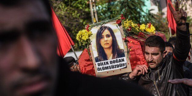 Pallbearers carry the coffin of Turkish woman Dilek Dogan during her funeral in Istanbul on October 26, 2015. Dogan, 25, died of her wounds on October 25 after being shot at home in Istanbul's Sariyer district during a police raid on October 18 as part of an operation into the Revolutionary People's Liberation Party/Front (DHKP/C). The circumstances of her death remain unclear. AFP PHOTO / OZAN KOSE (Photo credit should read OZAN KOSE/AFP/Getty Images)
