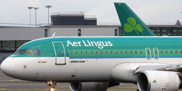 An Aer Lingus flight taxis at Dublin Airport in Ireland on January 27, 2015. Irish carrier Aer Lingus on Tuesday backed a 1.35-billion-euro ($1.51-billion) takeover bid from International Airlines Group, parent of British Airways and Iberia, in a deal aimed at slashing costs. AFP PHOTO / PAUL FAITH (Photo credit should read PAUL FAITH/AFP/Getty Images)