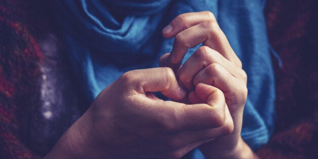 Close up on a young woman's hands as she is picking her nails