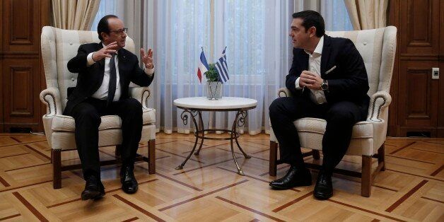 French President Francois Hollande, left, talks with the Greek Prime Minister Alexis Tsipras during their meeting at Maximos Mansion in Athens, Friday, Oct. 23, 2015. Hollande called Thursday for talks on relieving Greeceâs crushing debt load and investment, in combination with the harsh austerity measures international creditors have demanded over the past five years in return for vital rescue loans. (Yannis Kolesidis/Pool photo via AP)