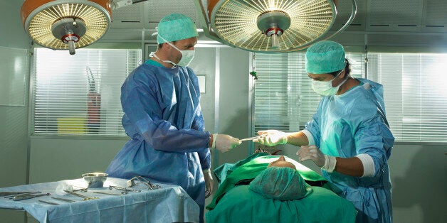 Two male surgeons performing surgery