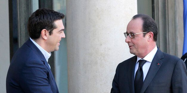 Greece's Prime Minister Alexis Tsipras, left, is greeted by French President Francois Hollande before a meeting at the Elysee Palace, in Paris, France, Wednesday, Feb. 4, 2015. In a short trip to Brussels before heading to France, Tsipras was welcomed at the European Commission, one of the three main institutions overseeing Greece's finances, by President Jean-Claude Juncker. (AP Photo/Christophe Ena)