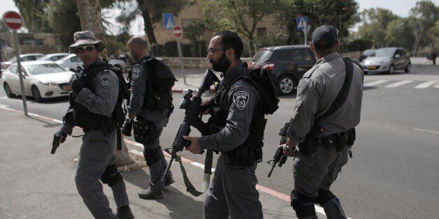 Israeli security forces conduct a search in the mixed French Hill neighbourhood in mostly-Arab east Jerusalem on October 13, 2015. Jerusalem suffered its bloodiest day yet in a wave of unrest, with at least three people killed and many wounded in shooting and car-and-knife attacks on Israelis. AFP PHOTO / AHMAD GHARABLI (Photo credit should read AHMAD GHARABLI/AFP/Getty Images)