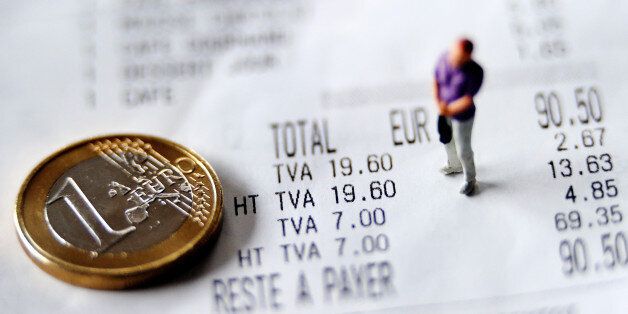 A picture taken on September 24, 2012 in Lille, shows an illustration made with a figurine and a one Euro coin set up on a receipt indicating the 7 percent rate of the Value Added Tax (VAT or TVA in French). AFP PHOTO PHILIPPE HUGUEN (Photo credit should read PHILIPPE HUGUEN/AFP/GettyImages)