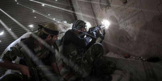 October 21, 2012 - Aleppo, Syria USA: Rebel fighters belonging to the Javata Harria Sham Qatebee watch over the enemy position during skirmishes at the first line of fire in Karmal Jabl neighborhood, district of Arkup, at the northeast of Aleppo CIty. (Narciso Contreras/POLARIS)