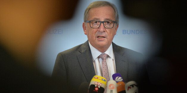 President of the European Commission Jean-Claude Juncker speaks to media during a visit of a migrants registration center in Passau, southern Germany, Thursday, Oct. 8, 2015. (AP Photo/Kerstin Joensson)