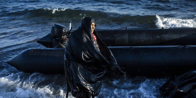 An elderly woman is pictured after arriving on the Greek island of Lesbos, after crossing the Aegean sea from Turkey, on October 15, 2015. More than 400,000 refugees, mostly Syrians and Afghans, arrived in Greece since early January while dozens were drowned trying to make the crossing. In total 710,000 have entered the EU through Greece and Italy during the same period, according to the European Agency Frontex border surveillance. The migration issue has caused deep divisions within the European Union, which is trying to set the distribution of migrants among its member countries or limit the flow. AFP PHOTO / DIMITAR DILKOFF (Photo credit should read DIMITAR DILKOFF/AFP/Getty Images)
