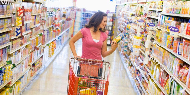 Woman shopping in supermarket aisle